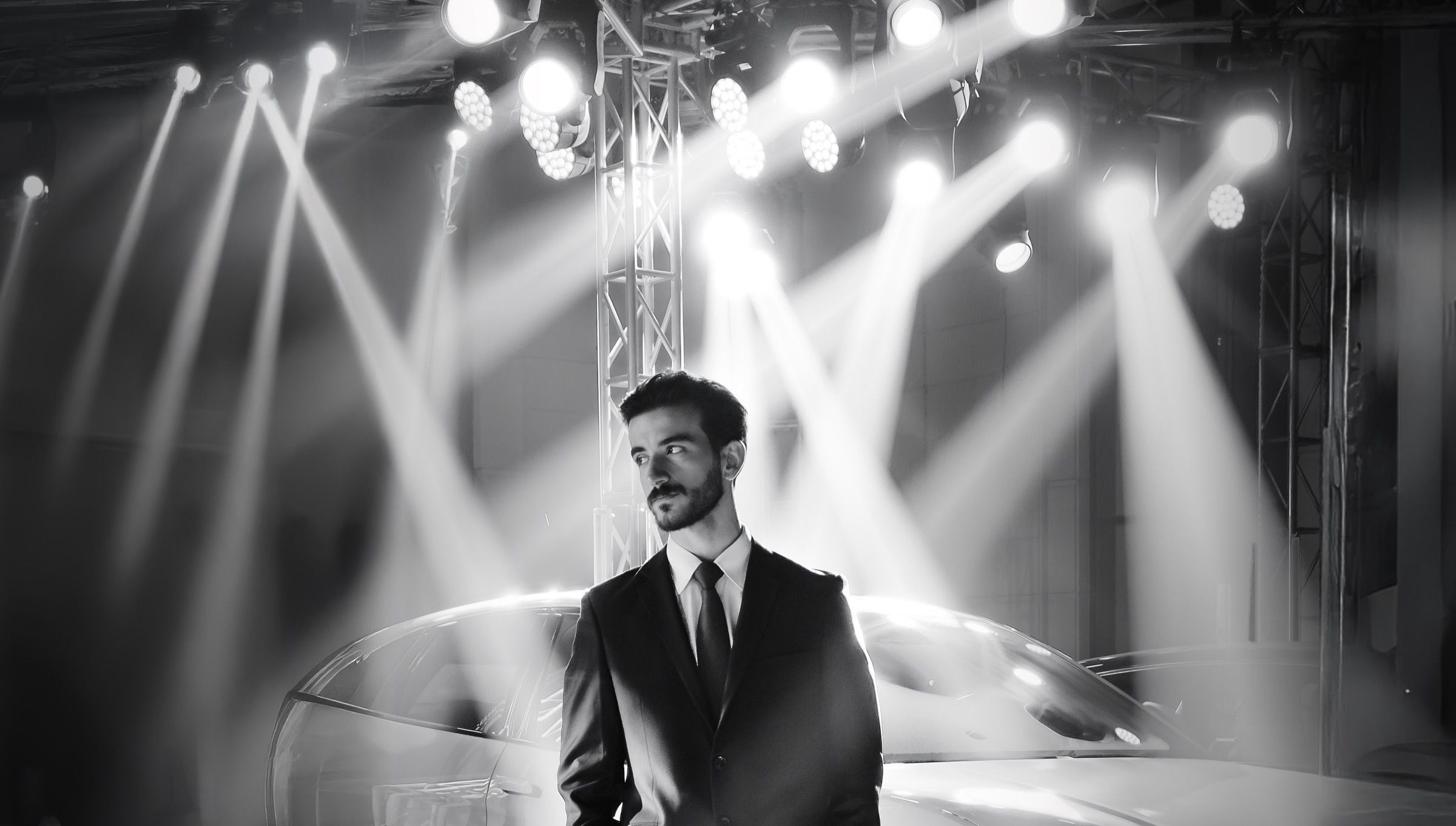 Yahya on set at a car launch, under stage lights